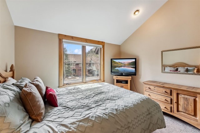 carpeted bedroom with vaulted ceiling