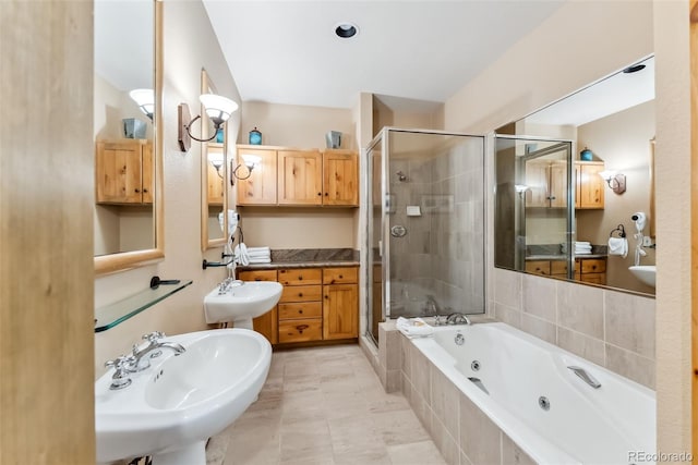 full bathroom with a shower stall, a tub with jets, and a sink