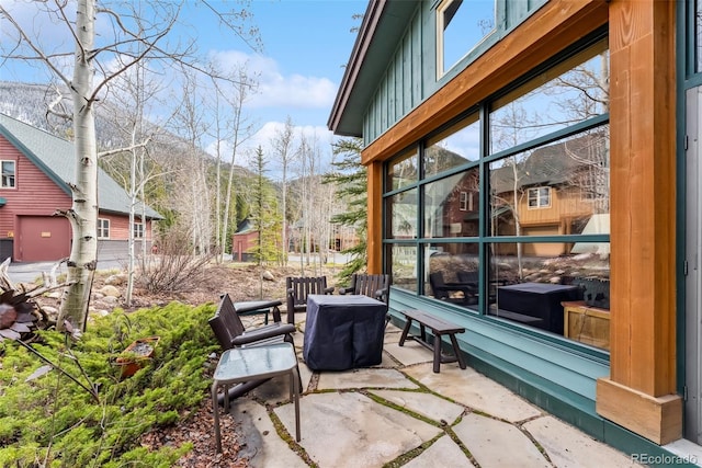 view of patio / terrace featuring a sunroom