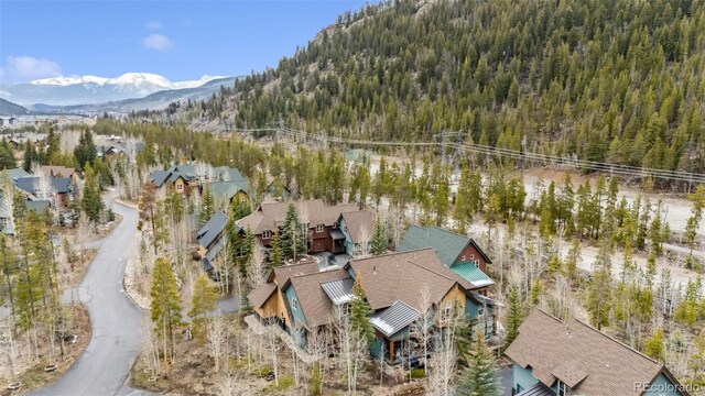view of property location featuring a forest and a mountainous background