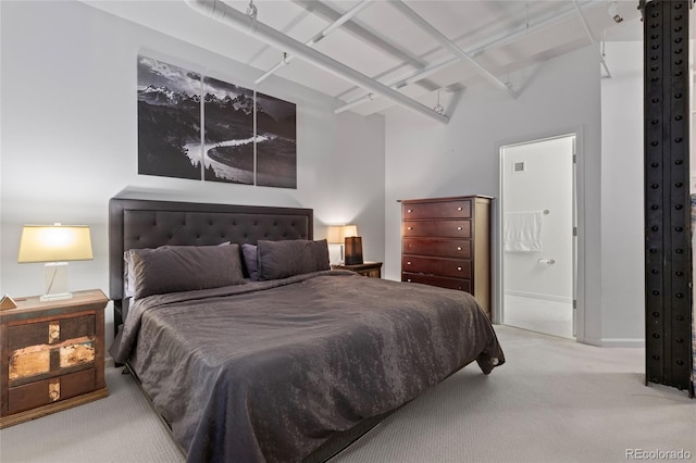 carpeted bedroom featuring ensuite bathroom