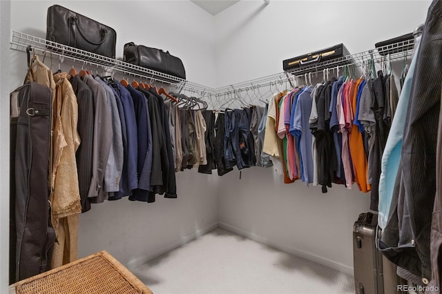 walk in closet featuring carpet flooring