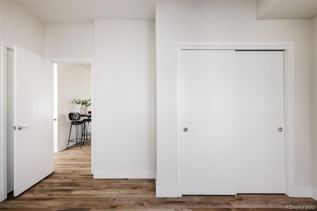 unfurnished bedroom with hardwood / wood-style floors and a closet