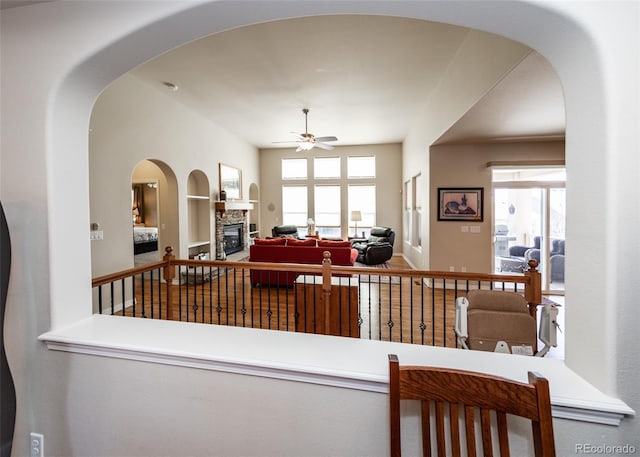 5279 Mount Cutler Ct, Colorado Springs, CO 80924 - interior space featuring a healthy amount of sunlight, ceiling fan, a fireplace, and built in shelves