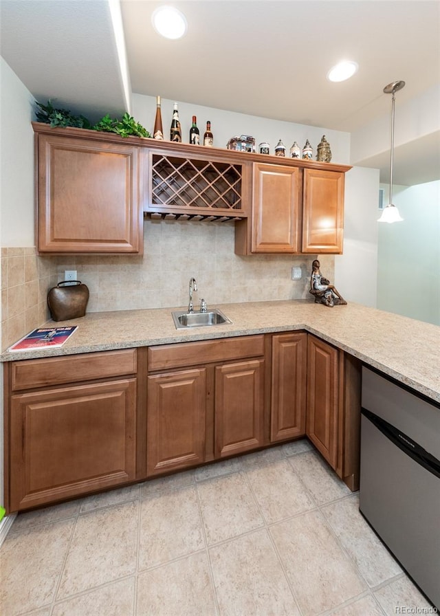 5279 Mount Cutler Ct, Colorado Springs, CO 80924 - kitchen featuring a sink, brown cabinets, decorative light fixtures, and tasteful backsplash