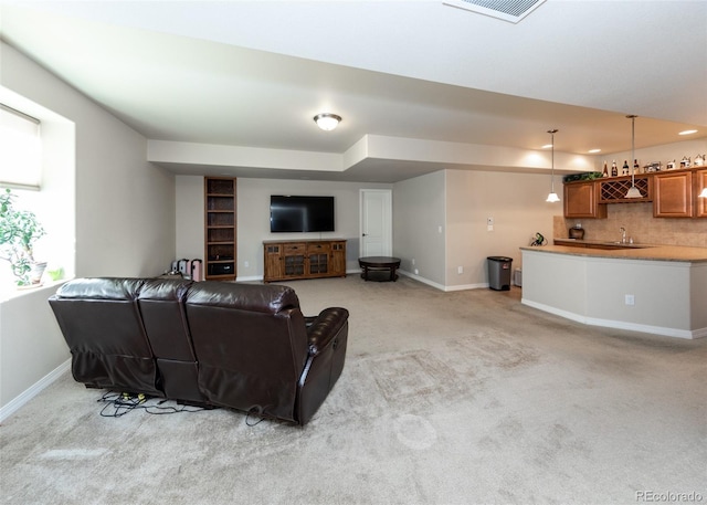 5279 Mount Cutler Ct, Colorado Springs, CO 80924 - living area with baseboards, light carpet, indoor wet bar, and visible vents