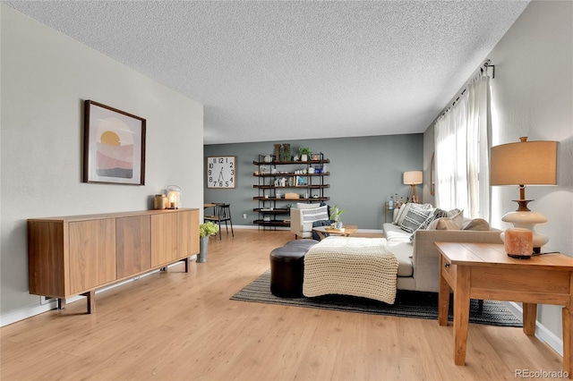 4782 E Costilla Ave, Centennial, CO 80122 - living room with light wood-style flooring, a textured ceiling, and baseboards