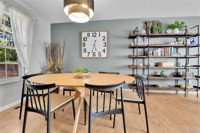 4782 E Costilla Ave, Centennial, CO 80122 - dining room with a textured ceiling, wood finished floors, and baseboards