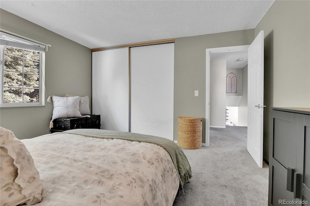 4782 E Costilla Ave, Centennial, CO 80122 - bedroom with light carpet, a textured ceiling, and a closet