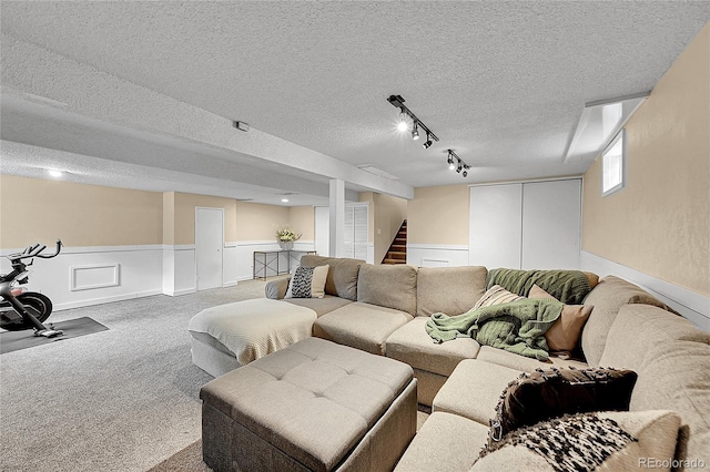 4782 E Costilla Ave, Centennial, CO 80122 - carpeted living area with a wainscoted wall, a textured ceiling, and stairs
