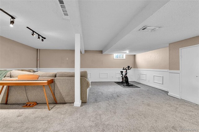 4782 E Costilla Ave, Centennial, CO 80122 - unfurnished living room with a textured ceiling, wainscoting, track lighting, and carpet