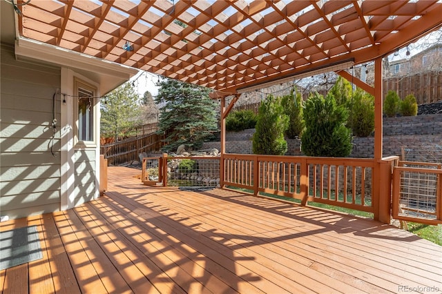 deck featuring fence and a pergola