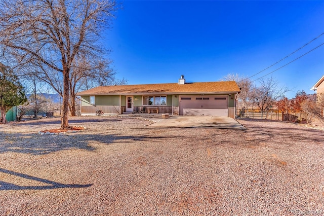 single story home with covered porch and a garage