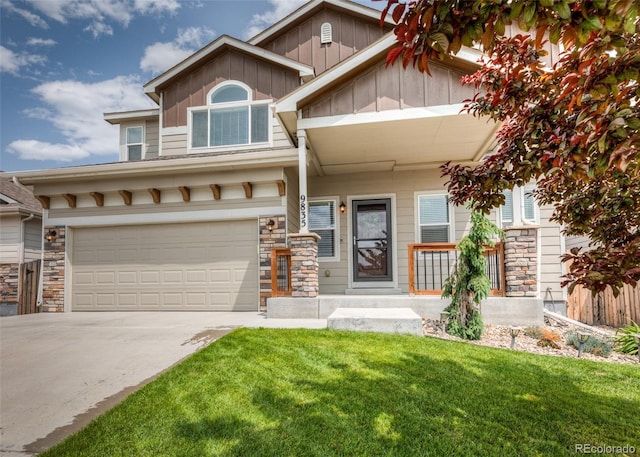 9835 Rubicon Dr, Colorado Springs, CO 80925 - view of front of home with a garage, stone siding, a front lawn, and board and batten siding