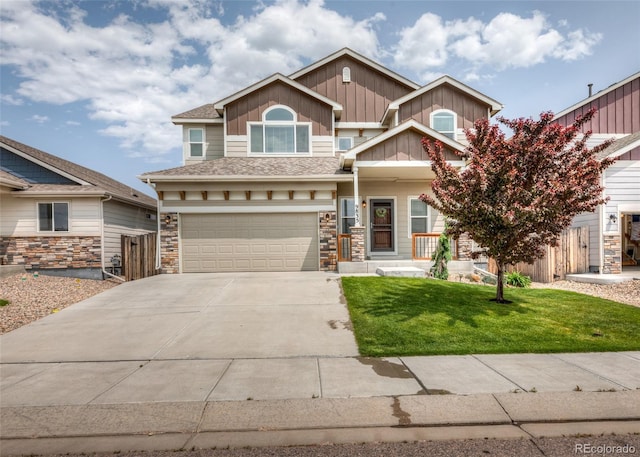 9835 Rubicon Dr, Colorado Springs, CO 80925 - view of front of house with concrete driveway, board and batten siding, an attached garage, and stone siding