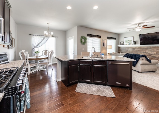 9835 Rubicon Dr, Colorado Springs, CO 80925 - kitchen with dishwasher, a sink, gas range, dark wood-style floors, and a ceiling fan