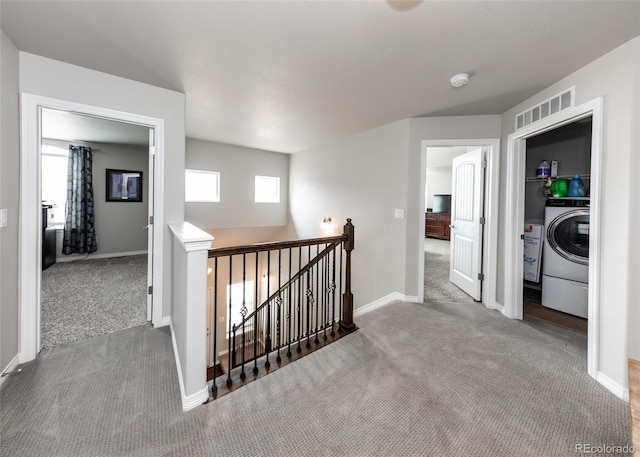 9835 Rubicon Dr, Colorado Springs, CO 80925 - corridor featuring washer / dryer, an upstairs landing, carpet flooring, and baseboards