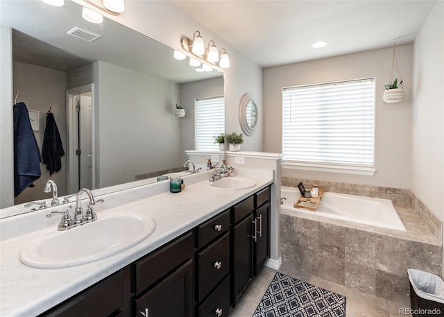 9835 Rubicon Dr, Colorado Springs, CO 80925 - bathroom with double vanity, a garden tub, and tile patterned floors