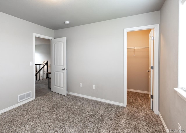 9835 Rubicon Dr, Colorado Springs, CO 80925 - unfurnished bedroom with carpet flooring, a spacious closet, and baseboards