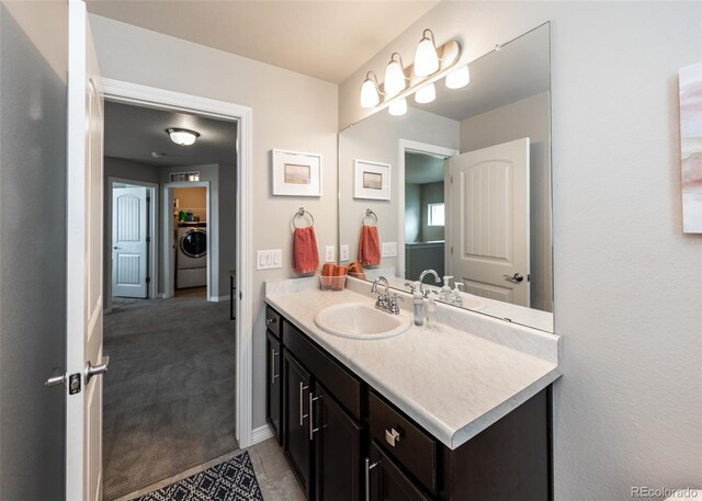 9835 Rubicon Dr, Colorado Springs, CO 80925 - bathroom with washer / dryer and vanity
