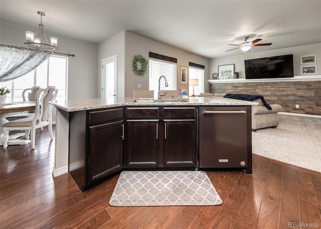 9835 Rubicon Dr, Colorado Springs, CO 80925 - kitchen featuring a sink, dishwasher, light stone counters, open floor plan, and a chandelier