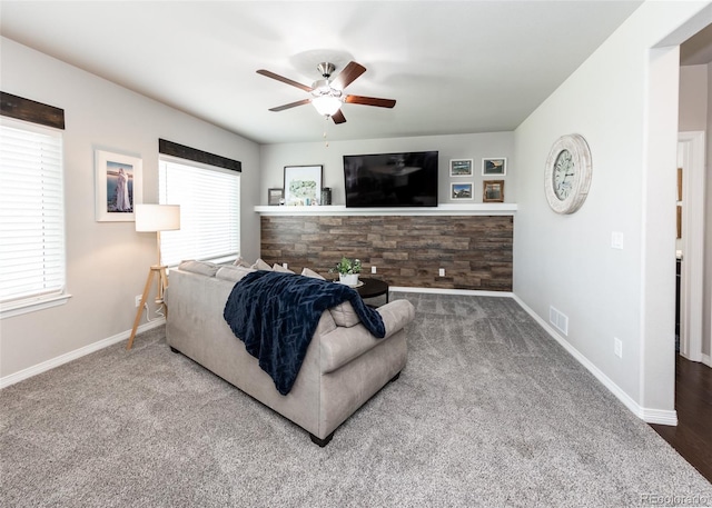 9835 Rubicon Dr, Colorado Springs, CO 80925 - carpeted living room featuring a ceiling fan, healthy amount of natural light, and baseboards