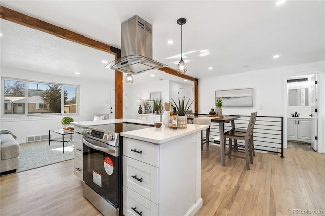 kitchen with white cabinetry, decorative light fixtures, electric range, beamed ceiling, and island exhaust hood