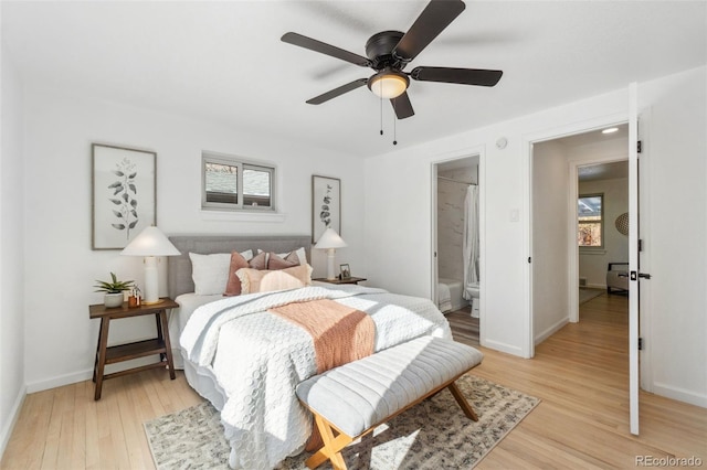 bedroom with ceiling fan, connected bathroom, and light hardwood / wood-style floors