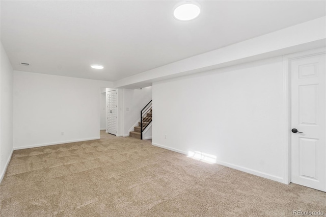 basement featuring light carpet