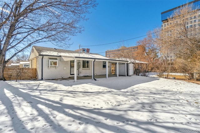 view of snow covered rear of property