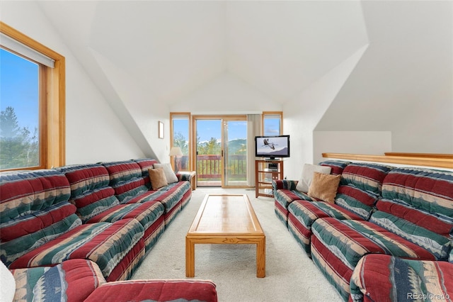 carpeted living room featuring vaulted ceiling