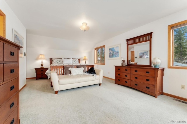 bedroom with light carpet and baseboards