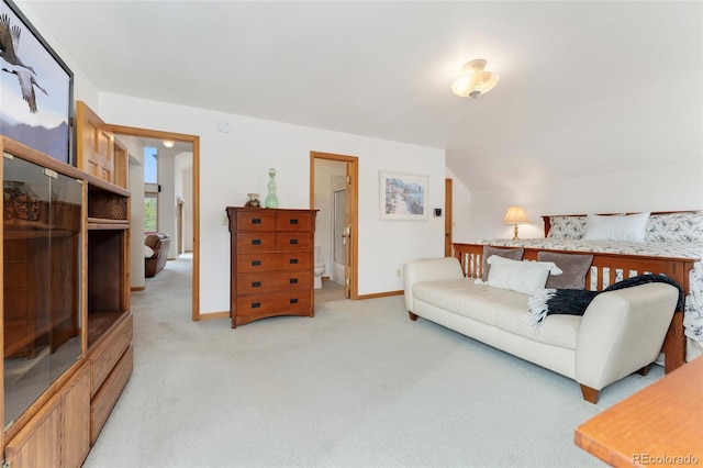 living area with light colored carpet, baseboards, and vaulted ceiling