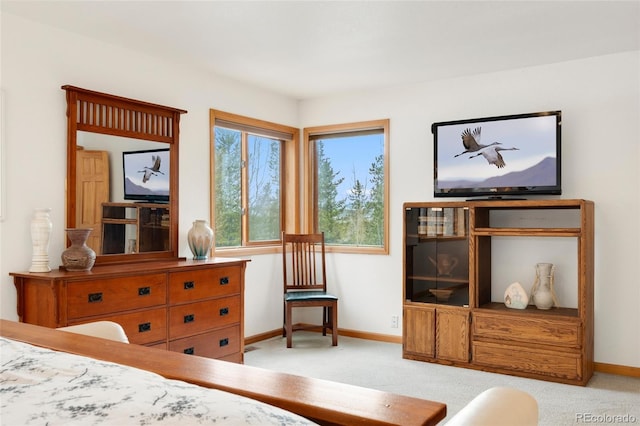 bedroom featuring baseboards and light carpet