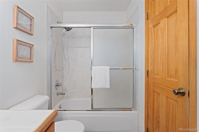 full bathroom featuring toilet, vanity, and enclosed tub / shower combo