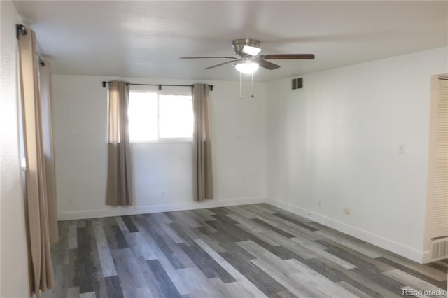 empty room with hardwood / wood-style floors and ceiling fan