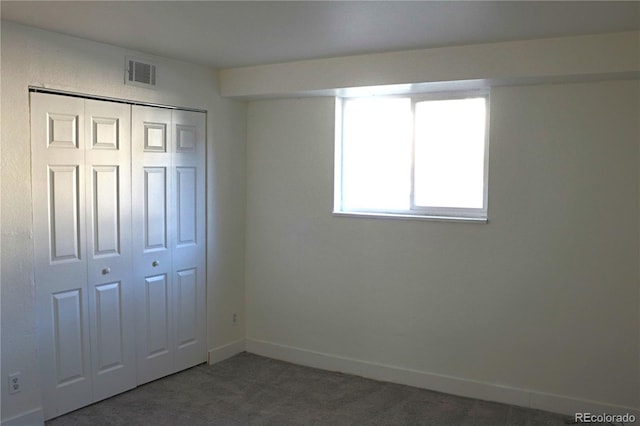 unfurnished bedroom with carpet flooring and a closet