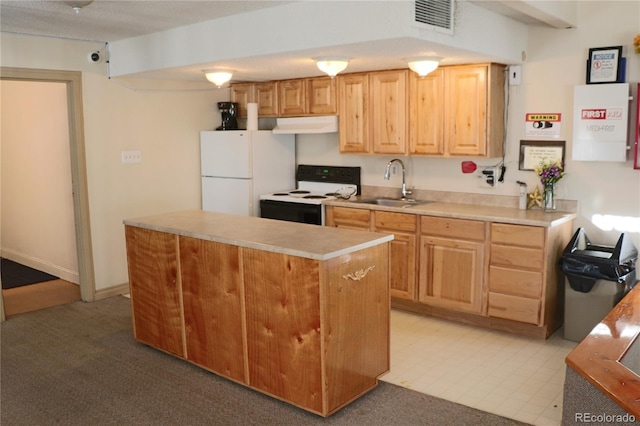 kitchen with carpet, sink, a kitchen island, and white appliances