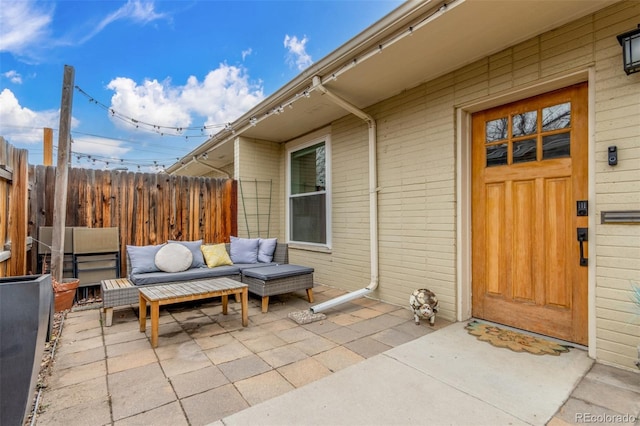 exterior space with outdoor lounge area and fence