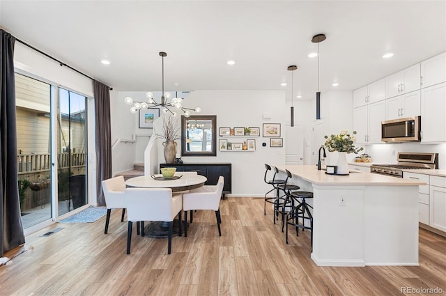 dining area featuring light wood-style floors, visible vents, an inviting chandelier, and recessed lighting