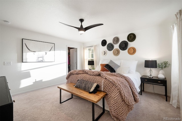 bedroom featuring light carpet, ceiling fan, and baseboards