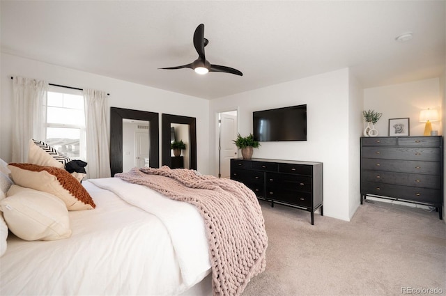 bedroom featuring light carpet and ceiling fan