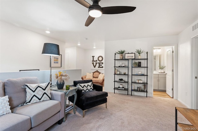 living area featuring light carpet, baseboards, visible vents, and recessed lighting