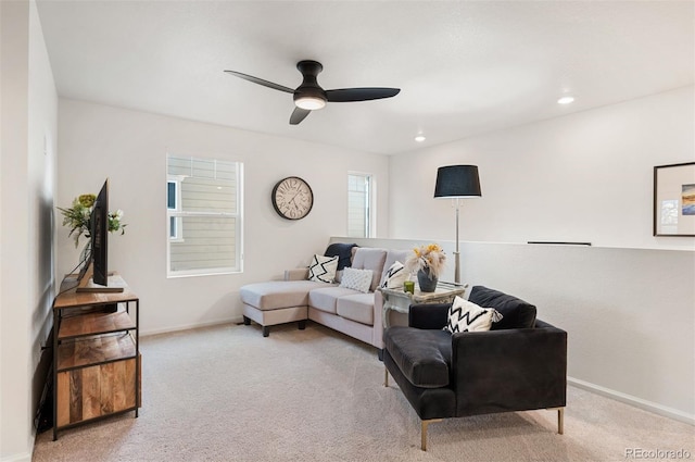 living area featuring light carpet, ceiling fan, recessed lighting, and baseboards