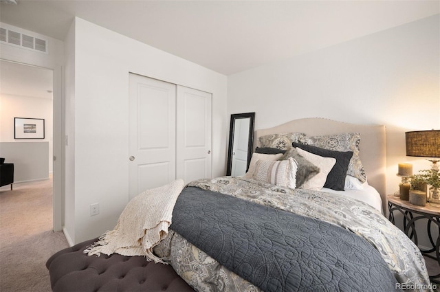 carpeted bedroom with baseboards, visible vents, and a closet