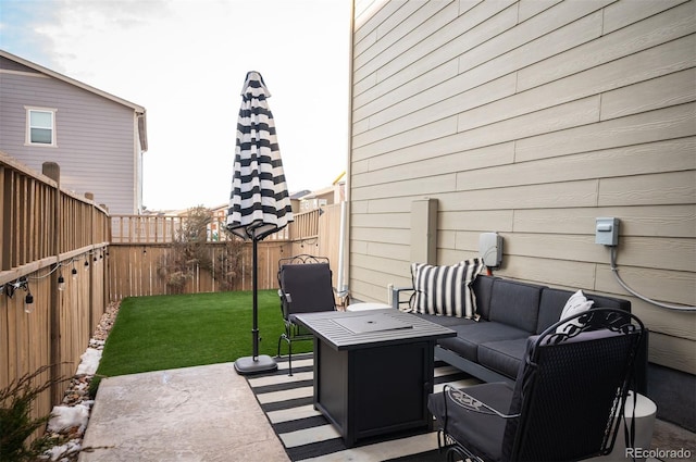 view of patio with an outdoor living space with a fire pit and a fenced backyard