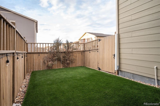 view of yard with a fenced backyard