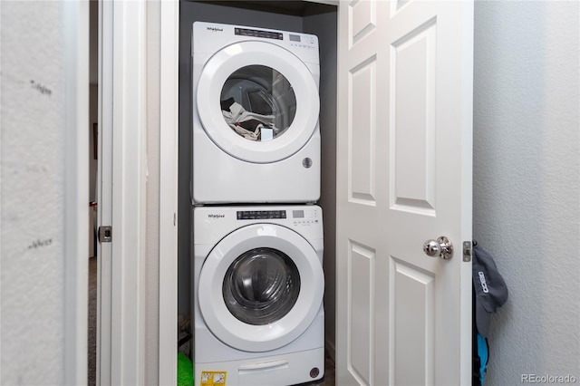 5672 Tramore Ct, Colorado Springs, CO 80927 - washroom with estacked washer and dryer and a textured wall