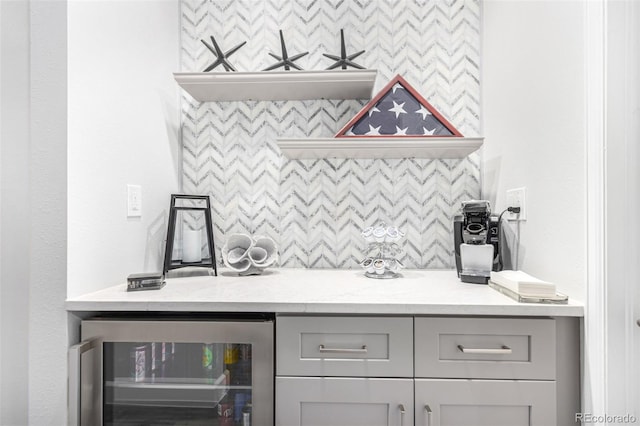 bar featuring decorative backsplash and beverage cooler