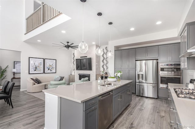 10524 Eby Cir, Lone Tree, CO 80124 - kitchen with stainless steel appliances, gray cabinetry, light wood finished floors, light countertops, and recessed lighting